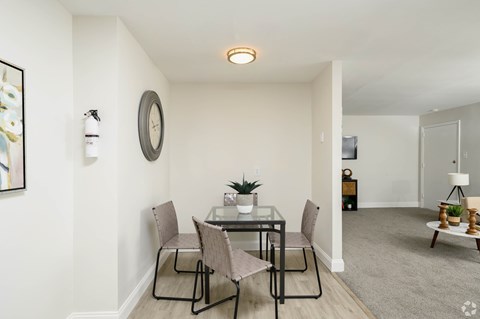 A dining room with a glass table and chairs.