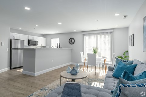 A modern living room with a grey sofa and a wooden coffee table.
