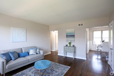 A living room with a couch, a chair, and a table.