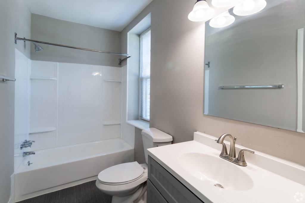Lincoln Court Apartments bathroom with sink toilet and tub