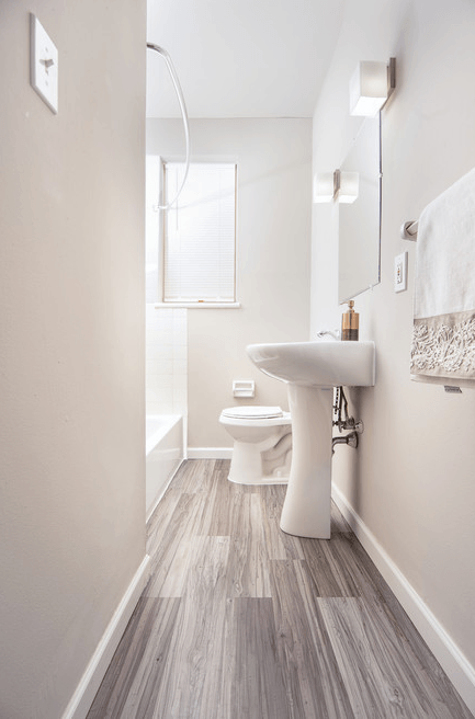 a white bathroom with a toilet and a sink