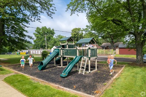 Kids running around a playground at Pottstown's Arbor Grove