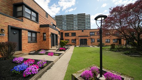 A brick building with a green lawn in front.
