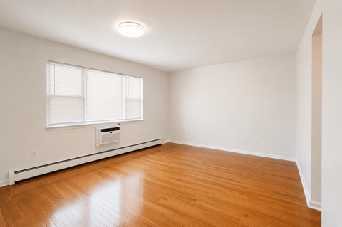 A room with a window and a radiator on the wall.
