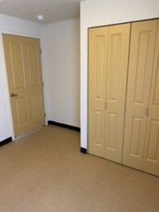 an empty room with two doors in it