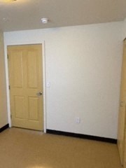 a room with a white wall and a door