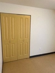 an empty room with two doors in it