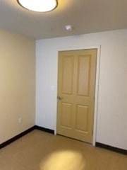 a room with a door and a light on the ceiling