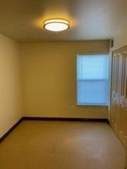 an empty room with a window and a door