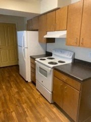 a kitchen with a white stove and a refrigerator