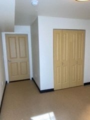 an empty room with two doors in it