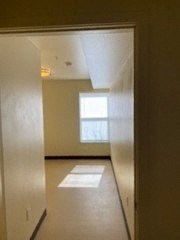 an empty living room with a window in it