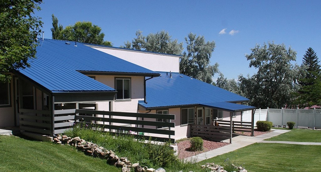 a house with a blue roof and a yard