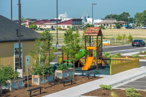 a playground in a park next to a building