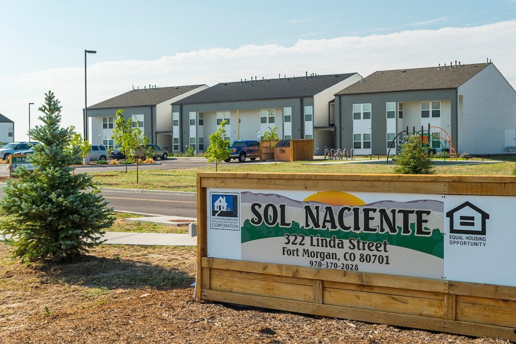 a sign that reads soil nacelle in front of some houses
