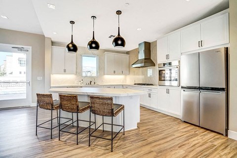 a large kitchen with white cabinets and a counter top