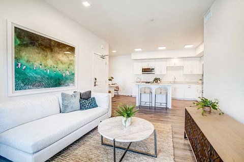 a living room with a white couch and a table