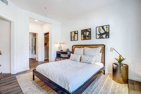 a bedroom with a bed and a rug