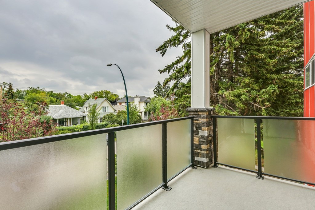 the upstairs balcony has a view of the neighborhood and trees