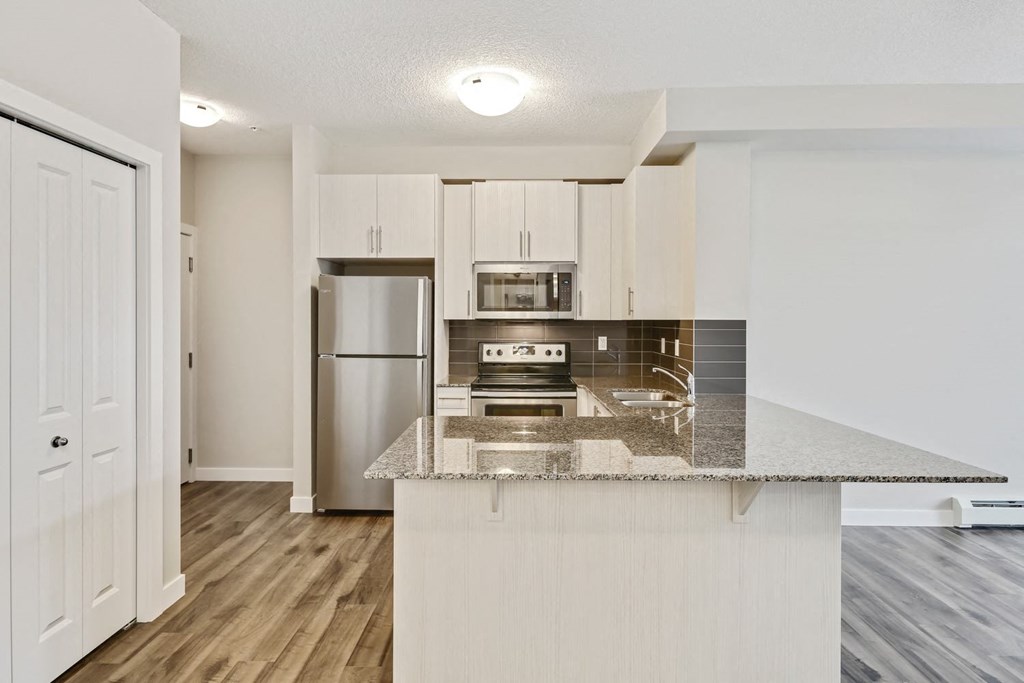 a kitchen with a counter top and a refrigerator