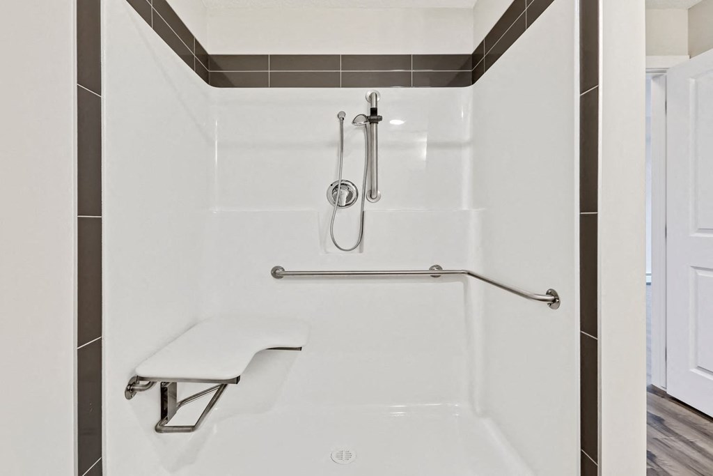 a white bathroom with a shower and a bench
