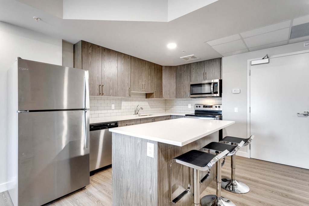 a kitchen with stainless steel appliances and a white counter top