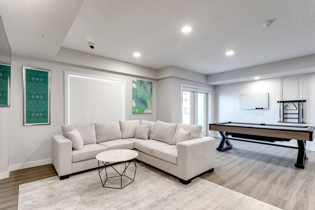 a living room with a couch and a pool table