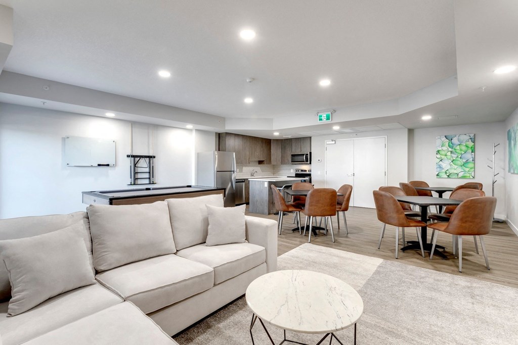 a living room and kitchen with a couch and a table