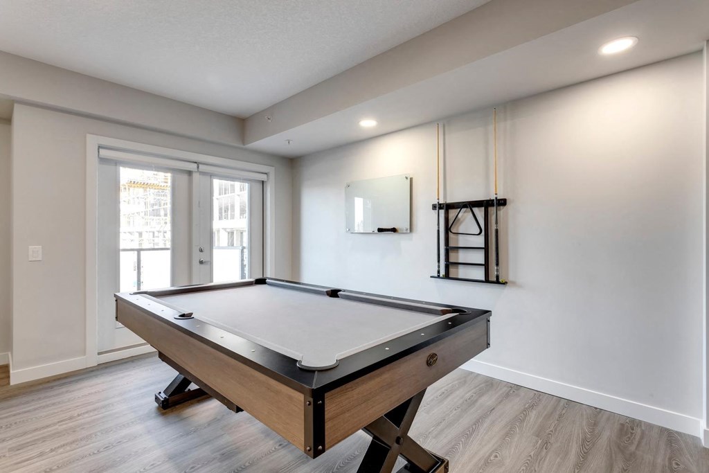 a room with a pool table and a window