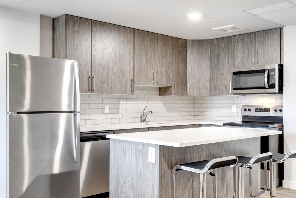 a kitchen with stainless steel appliances and a white counter top