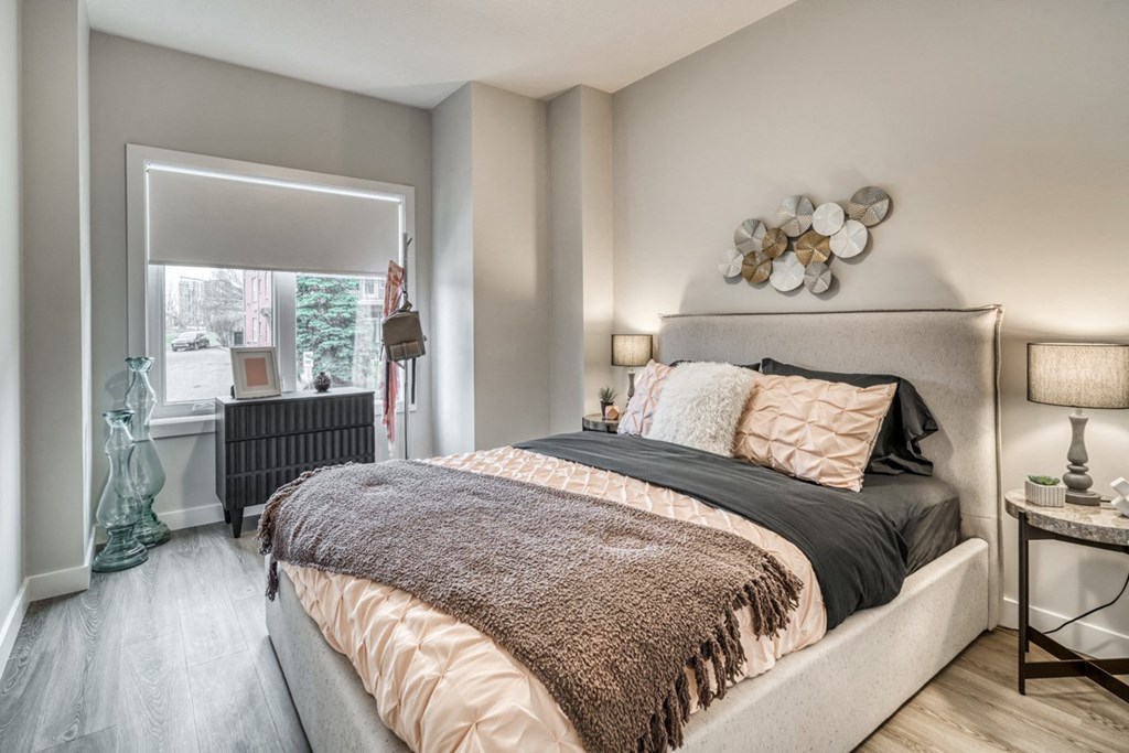 a bedroom with a bed and a window