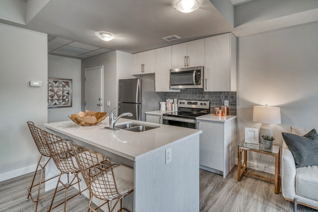 2 bedroom apartment kitchen with a white counter top and a sink