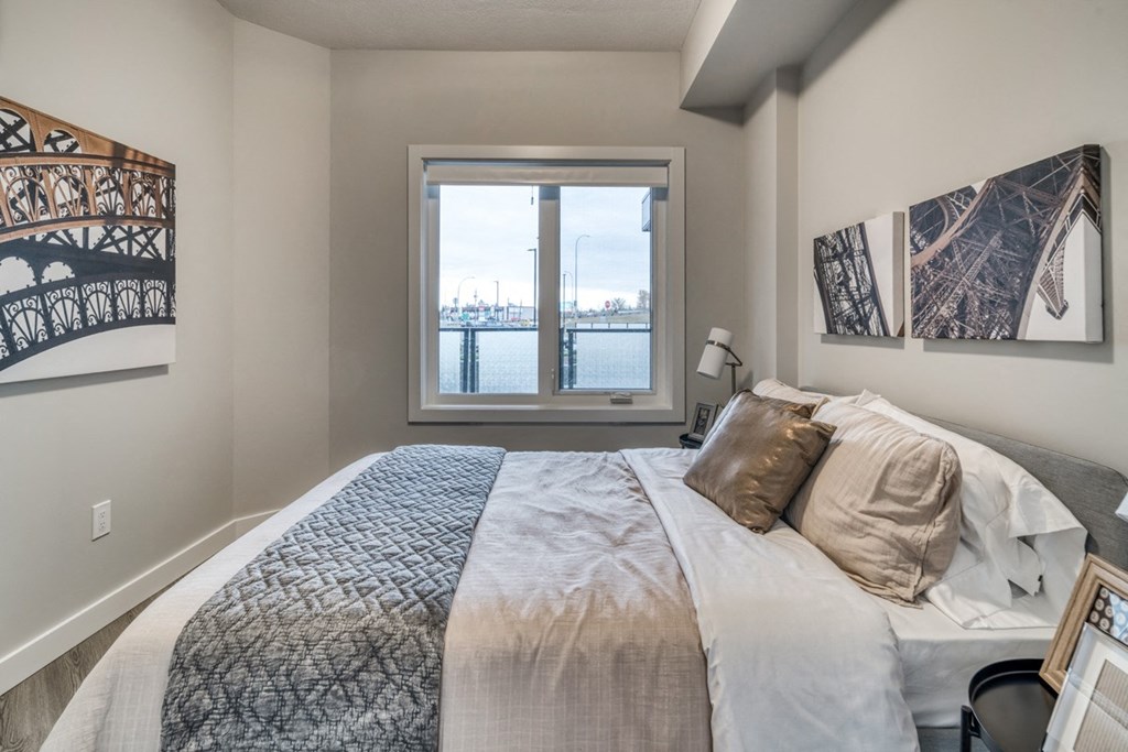 a bedroom with a large bed and a window