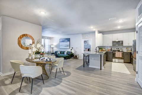 A modern kitchen with a dining table set for four.