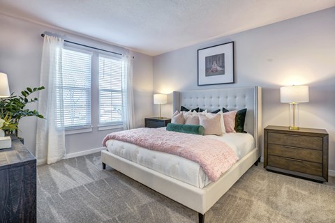 Furnished bedroom with carpeted floors