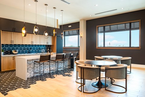 A modern kitchen with a dining table and chairs.