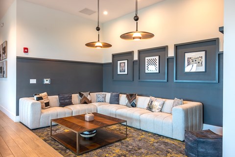 A living room with a white couch and a coffee table.