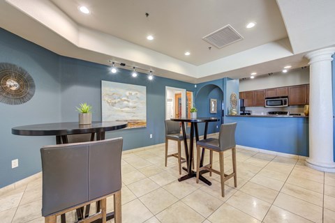 A kitchen with a dining table and chairs.