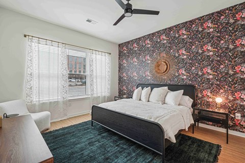 a bedroom with a bed and a ceiling fan