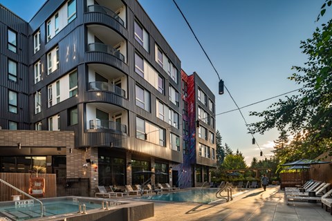 A modern building with a pool in front.