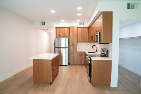 A kitchen with wooden cabinets and a white countertop.