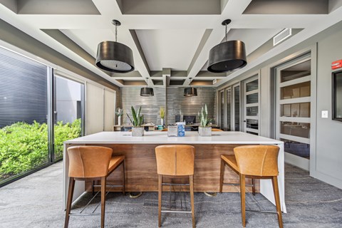 A modern kitchen with a dining table and chairs.