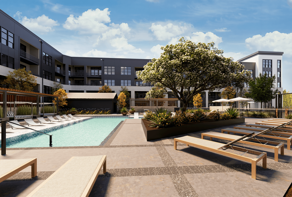 a pool with lounge chairs and a building in the background