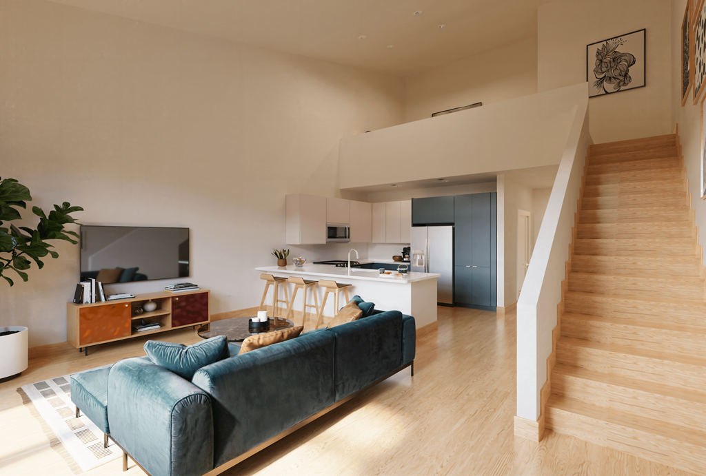 a living room with a blue couch and a kitchen with a staircase