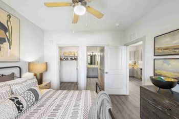 a bedroom with a bed and a ceiling fan