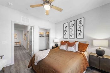 a bedroom with a bed and a ceiling fan