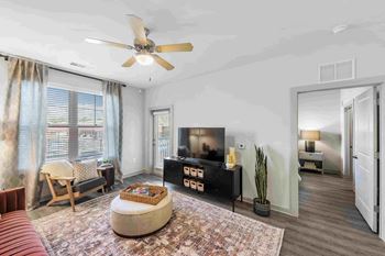 a living room with a couch and a ceiling fan