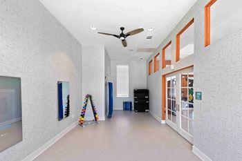 a corridor with a ceiling fan and a ladder