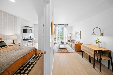 A modern bedroom with a large bed and a wooden table.