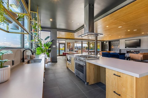 A modern kitchen with wooden cabinets and a large island.